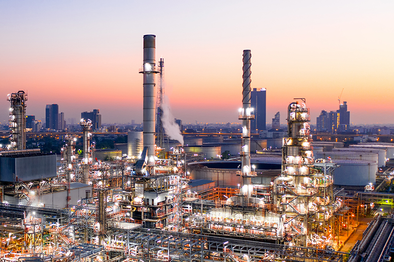 Aerial view of oil refinery during sunrise. Figure 1. Crude Oil Refineries generate petroleum coke waste in large amounts.